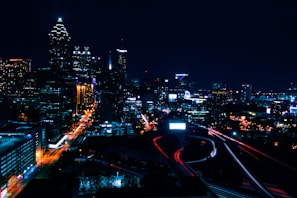 A vibrant city skyline with cars in motion.