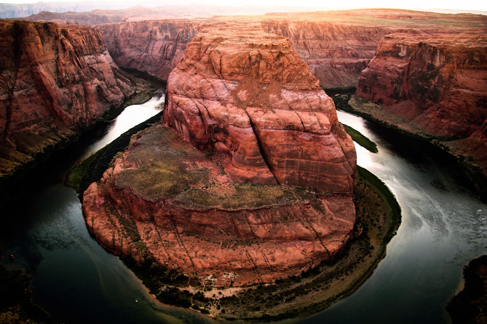 brown rocky mountain and body of water at daytime