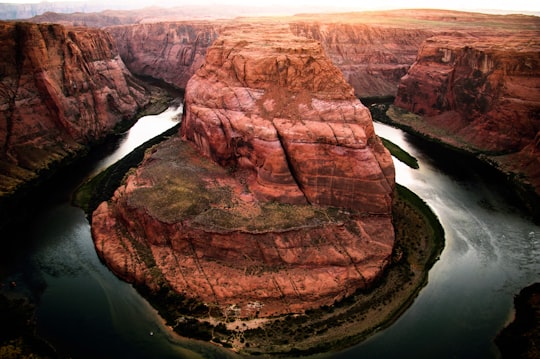 brown rocky mountain and body of water at daytime in Page United States