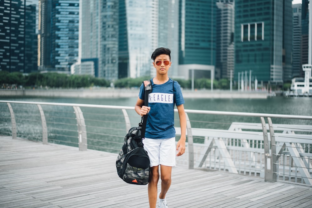 man standing beside river