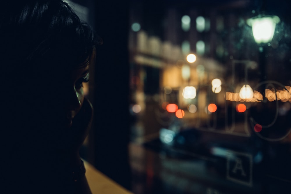 woman sitting on edges of building