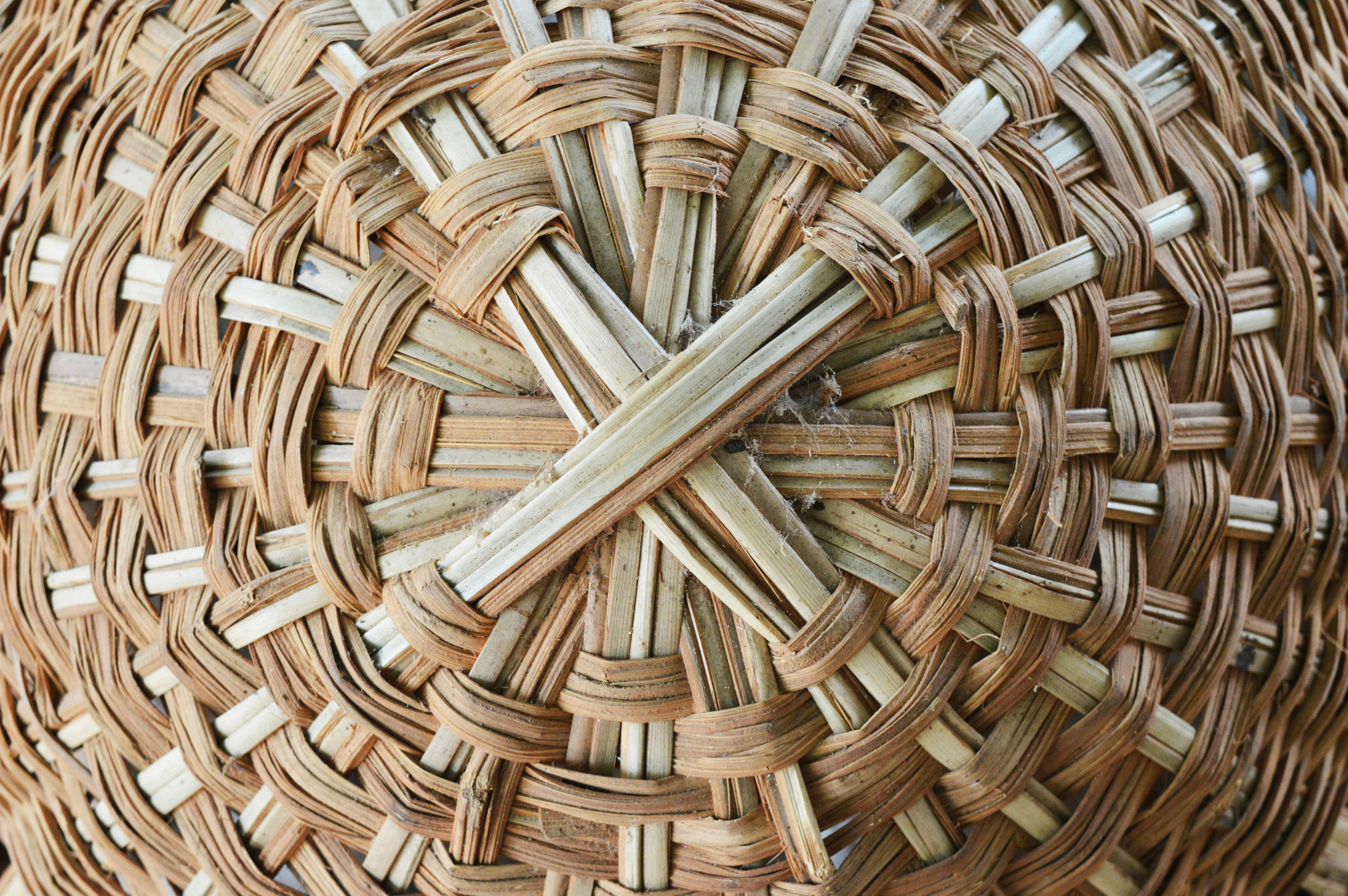 Artisan hands weaving traditional African basket, close up, warm earth tones, natural fibers, detailed craft work