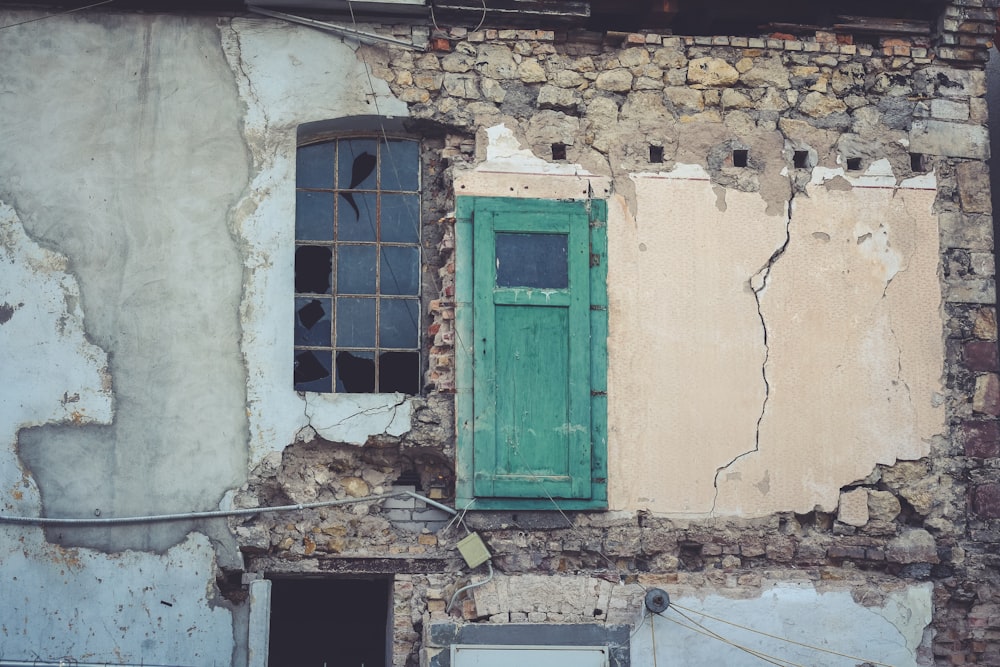 an old building with a green door and window