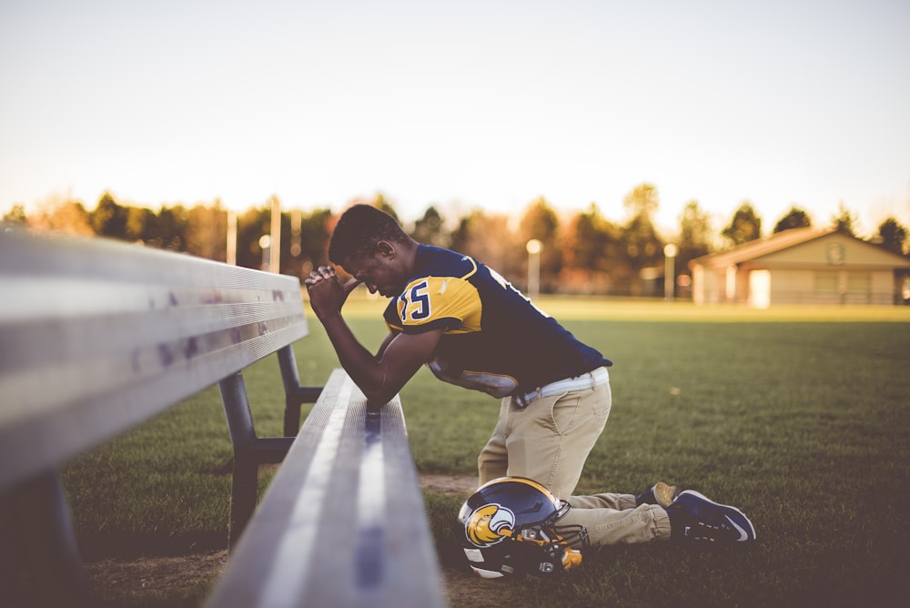 baseball player kneeling on ground