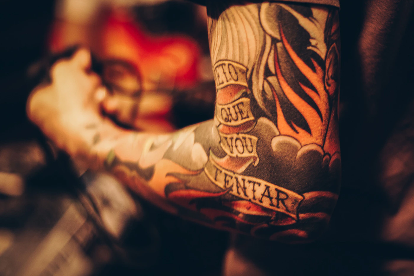 Close-up of a person's tattooed arm skin, representing the area reviewed across a staged laser tattoo removal course