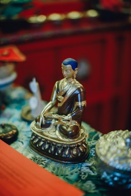 A serene image of a golden Sri Yantra glowing softly against a deep red background.