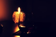 Inviting scene of a candle lit next to a cup of hot chocolate, evoking warmth and comfort