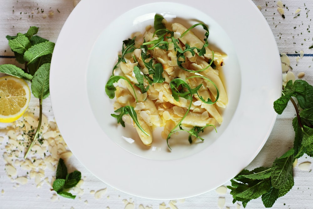 round white ceramic plate with pasta