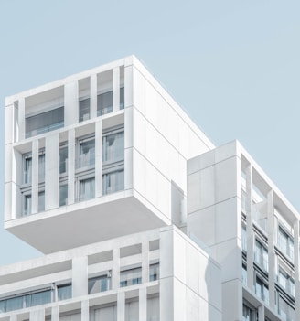 white modern cement building under blue sky