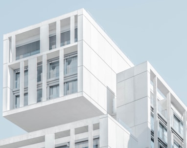 white modern cement building under blue sky