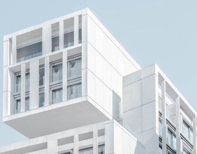 white modern cement building under blue sky