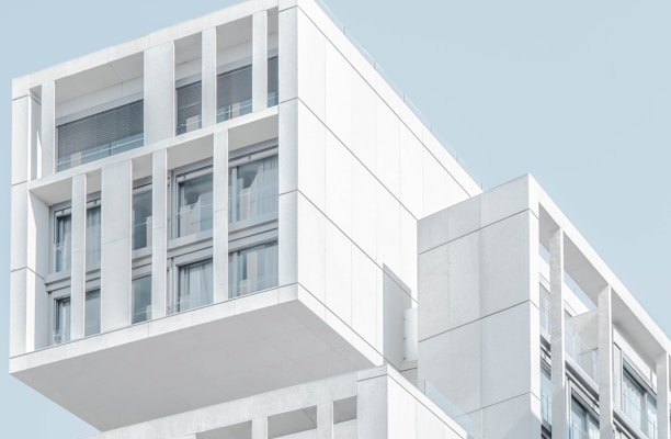 white modern cement building under blue sky