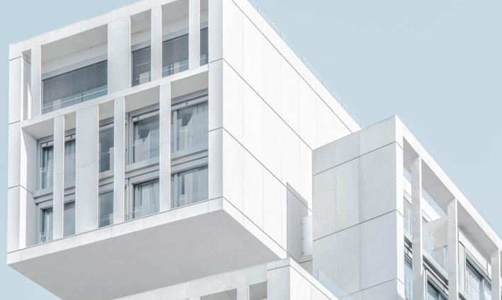 white modern cement building under blue sky