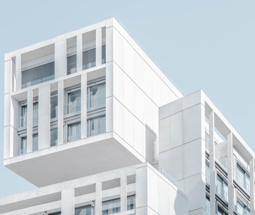 white modern cement building under blue sky