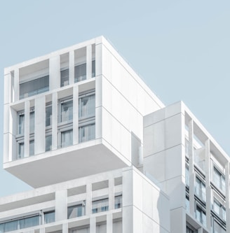 white modern cement building under blue sky