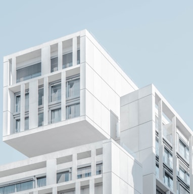 white modern cement building under blue sky