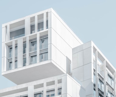 white modern cement building under blue sky