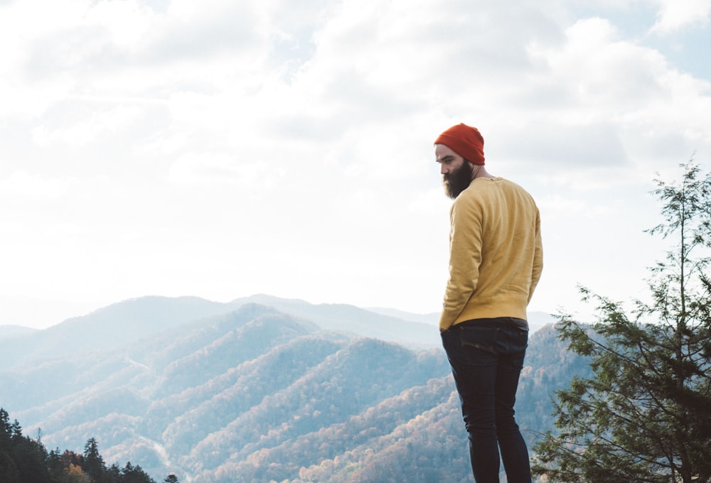 man standing on top of hill