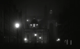 A moody black-and-white shot of a nighttime cityscape with Ghostville’s logo subtly glowing.
