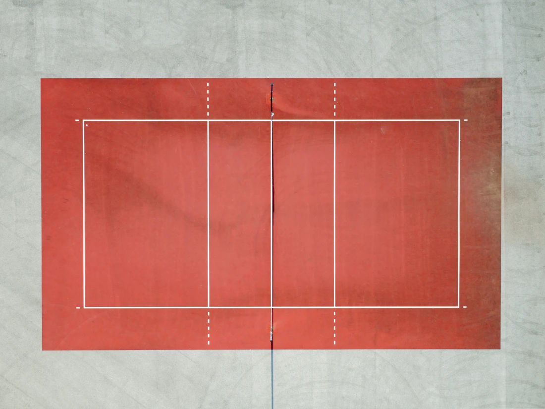 An empty volleyball court photographed from directly overhead