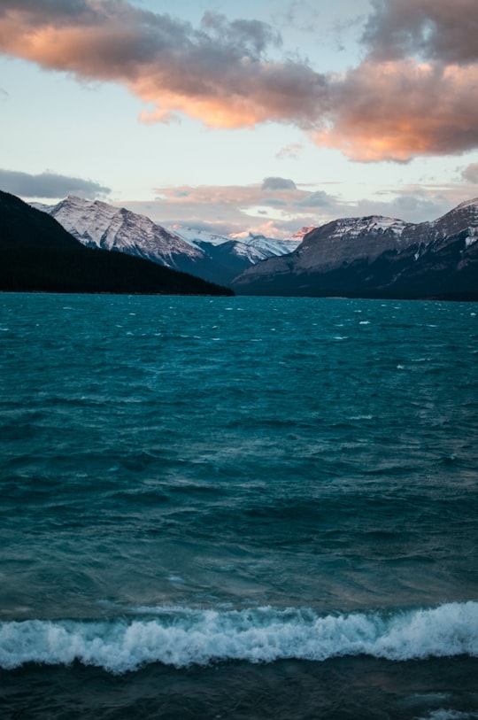 mountains near body of water under white clouds in Rocky Mountain House Canada