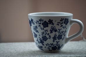 A set of hand-painted ceramic mugs with floral designs.