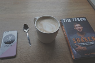 Close-up of a tablet screen displaying the cover of 'Chosen Without Chasing' with a cup of tea nearby.