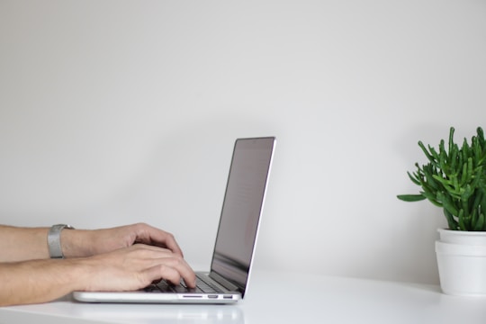 hands typing on laptop to create website