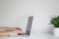 Close-up of hands typing on a sleek laptop with a minimalist background.