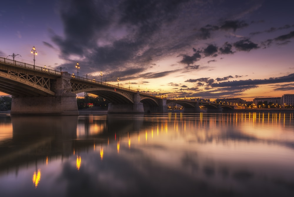 gray concrete bridge under cloudy sky