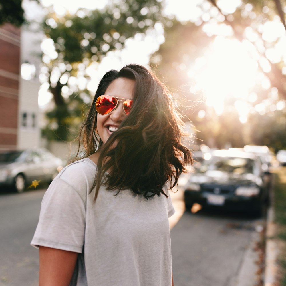 woman wearing white T-shirt smiling