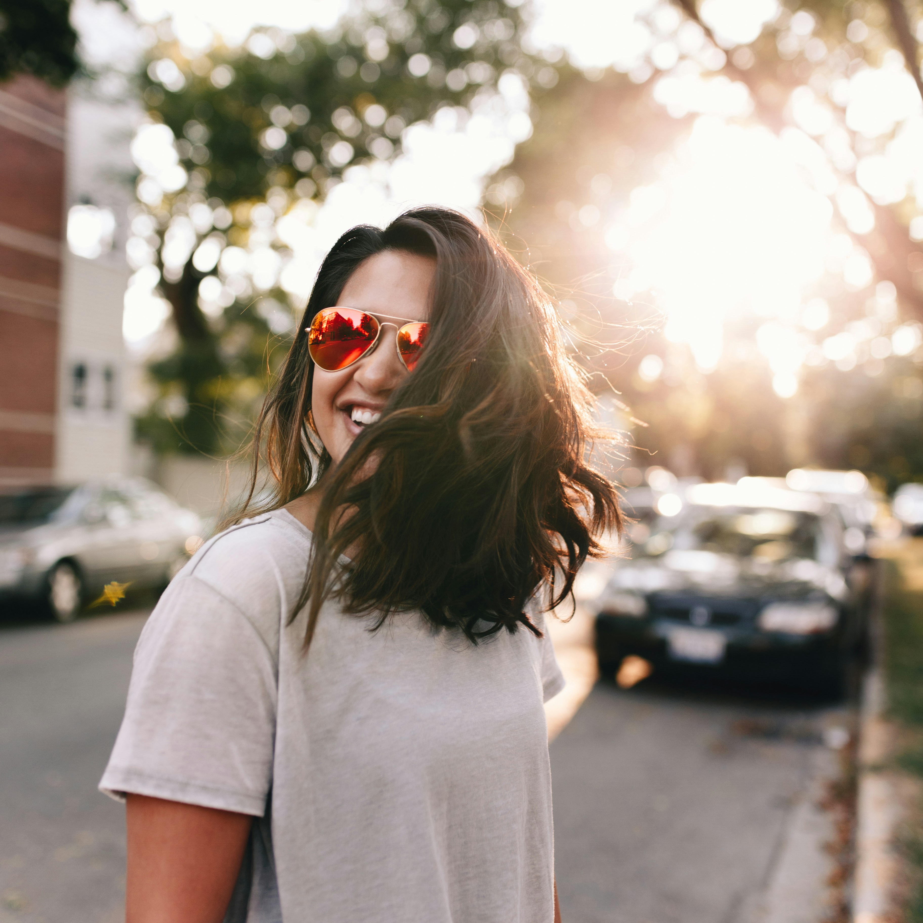 Close-up of a young girl wearing glasses, smiling.