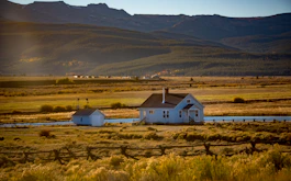 teal and black wooden house beside teal and black house