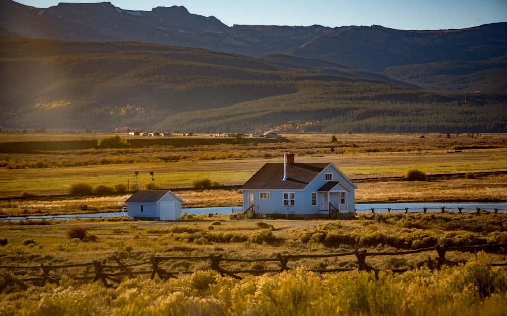 teal and black wooden house beside teal and black house