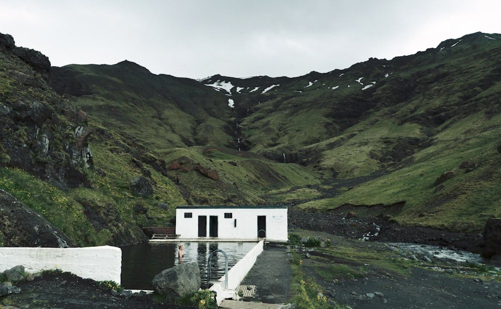 swimming pool surrounded by green mountain