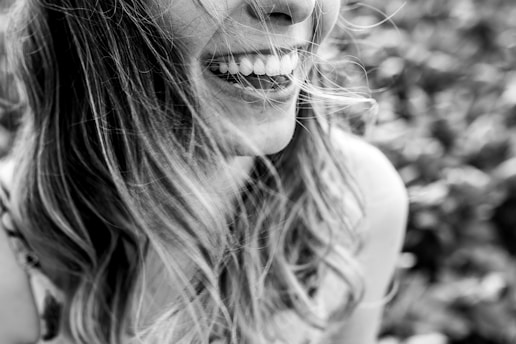 Close-up photo of a smiling female dentist in a modern dental clinic.