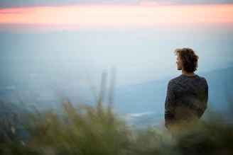 men's black sweater during sunset