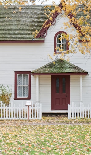 white house under maple trees