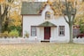 white house under maple trees