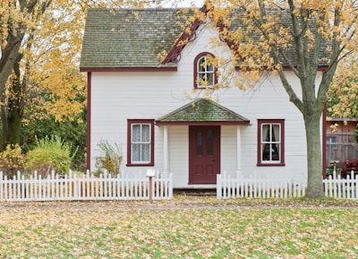 white house under maple trees