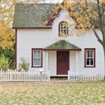 white house under maple trees