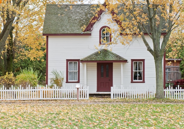 white house under maple trees