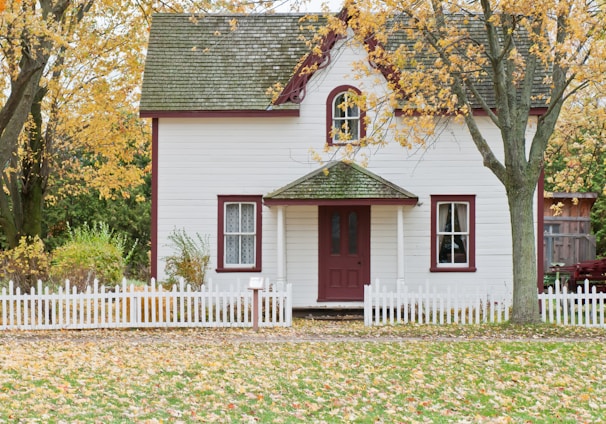 white house under maple trees