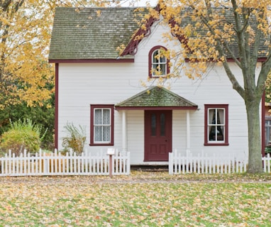 white house under maple trees