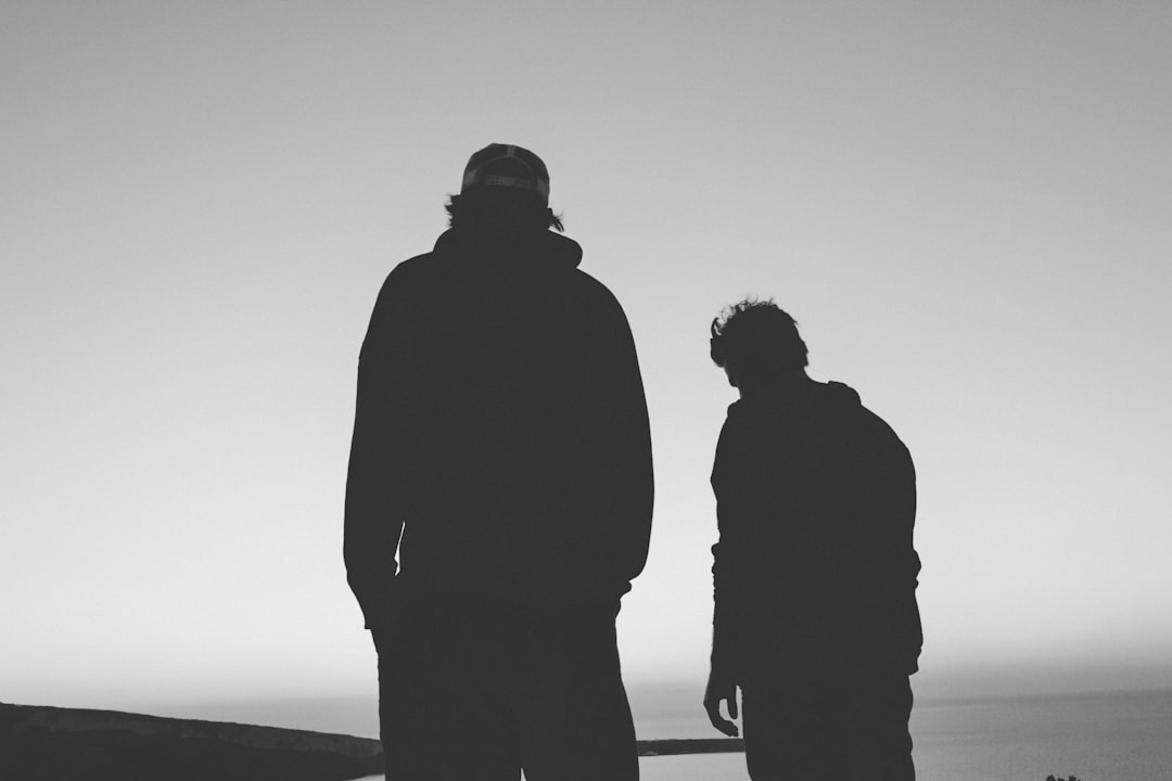 silhouette of two man
