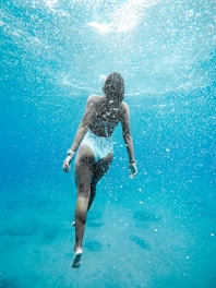 woman swimming under water