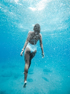 woman swimming under warm water