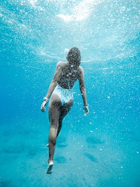 woman swimming under water