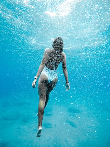 woman swimming under warm water