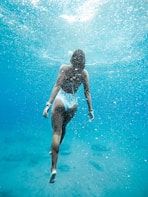 woman swimming under water